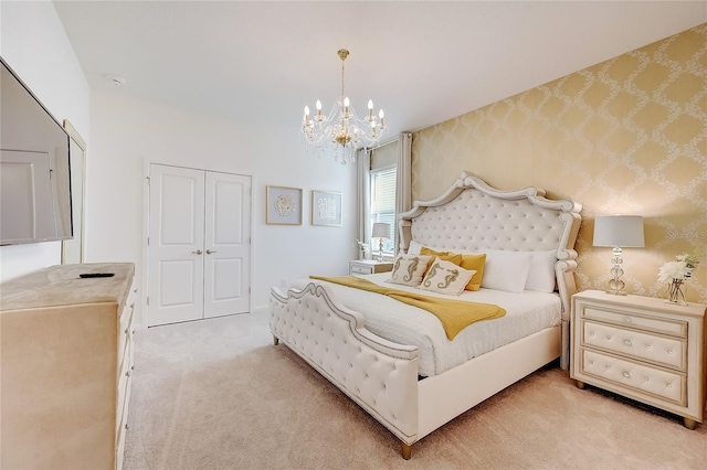 carpeted bedroom featuring a notable chandelier and a closet