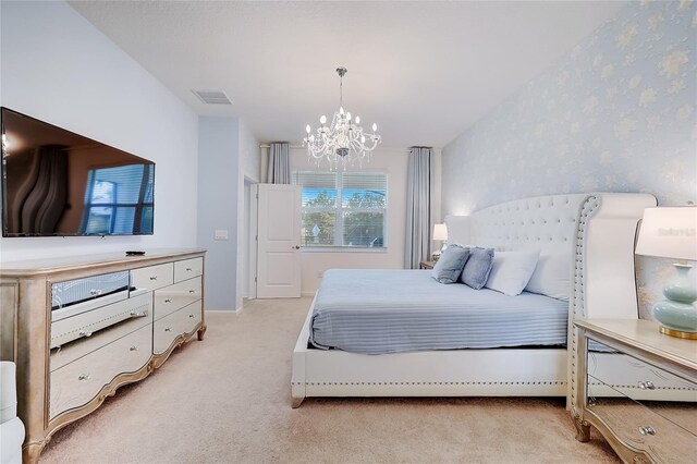 carpeted bedroom with an inviting chandelier