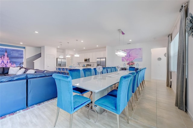 dining room featuring a notable chandelier, light tile patterned floors, and sink