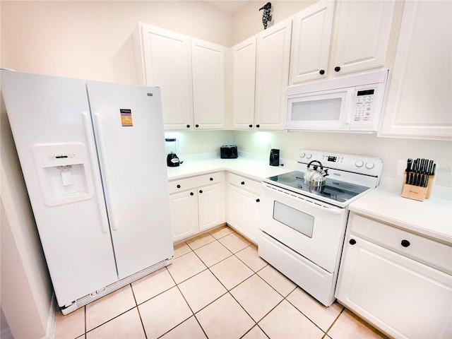 kitchen with white appliances, white cabinets, and light tile flooring