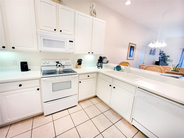 kitchen featuring a notable chandelier, light tile floors, white cabinets, and white appliances