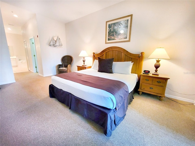 carpeted bedroom featuring ensuite bath