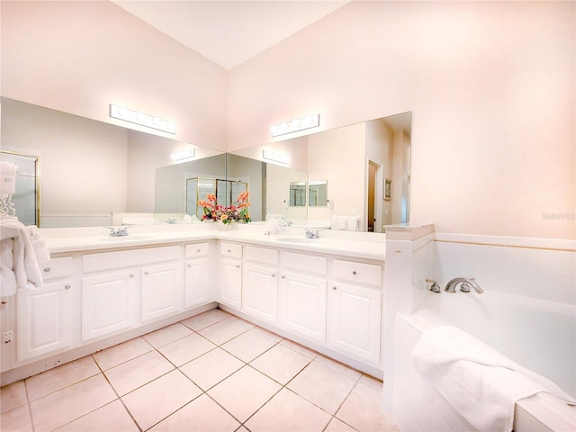 bathroom featuring double vanity, tile flooring, and a bath