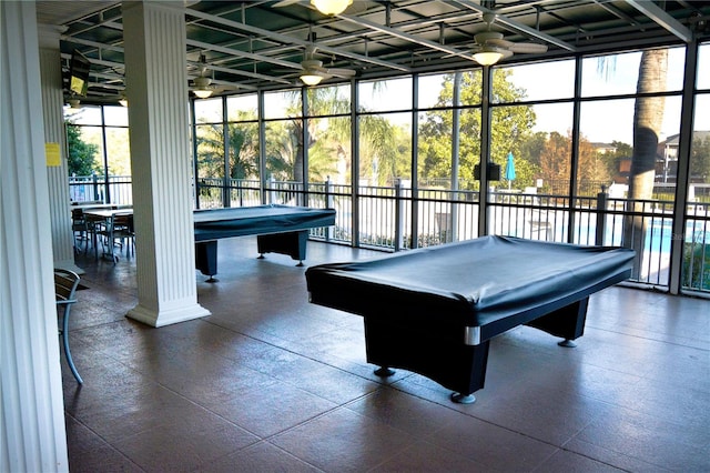 game room featuring dark tile flooring, billiards, ceiling fan, and expansive windows