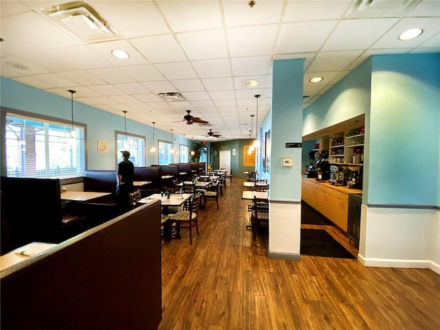 office space with dark hardwood / wood-style floors, ceiling fan, and a paneled ceiling