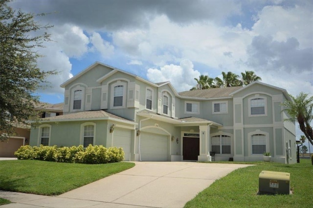 view of front of house featuring a front lawn and a garage