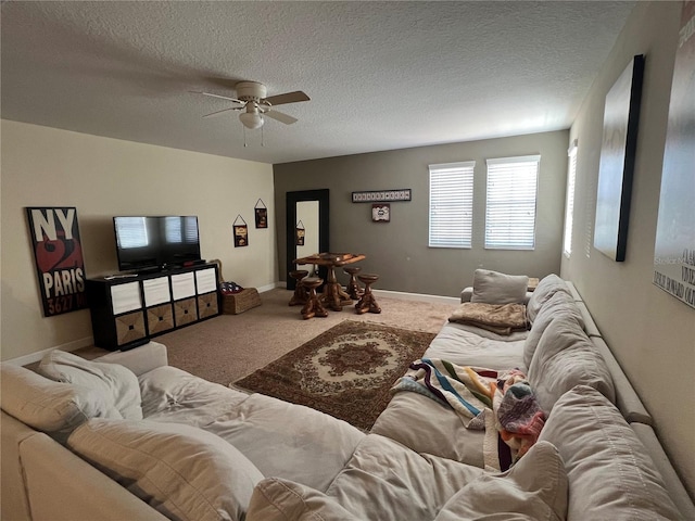 carpeted living room featuring ceiling fan and a textured ceiling