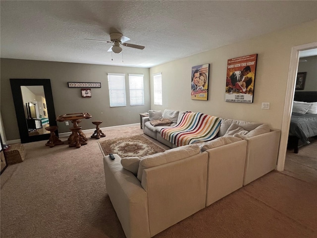 living room featuring ceiling fan, carpet floors, and a textured ceiling