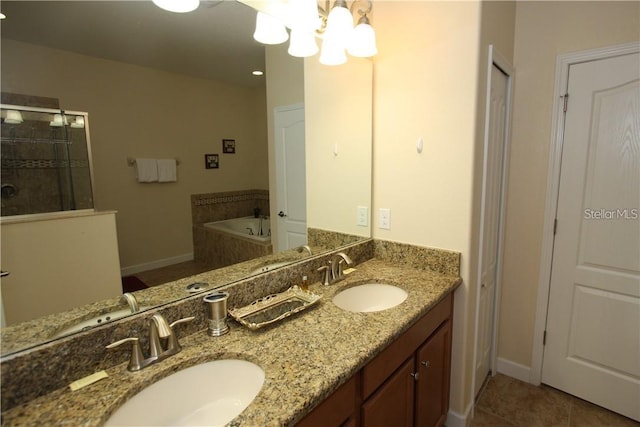 bathroom featuring independent shower and bath, vanity, tile patterned floors, and an inviting chandelier