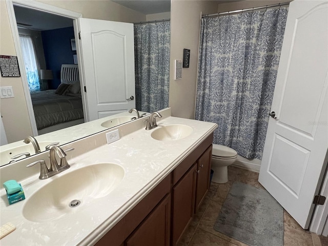 bathroom with tile patterned floors, vanity, and toilet