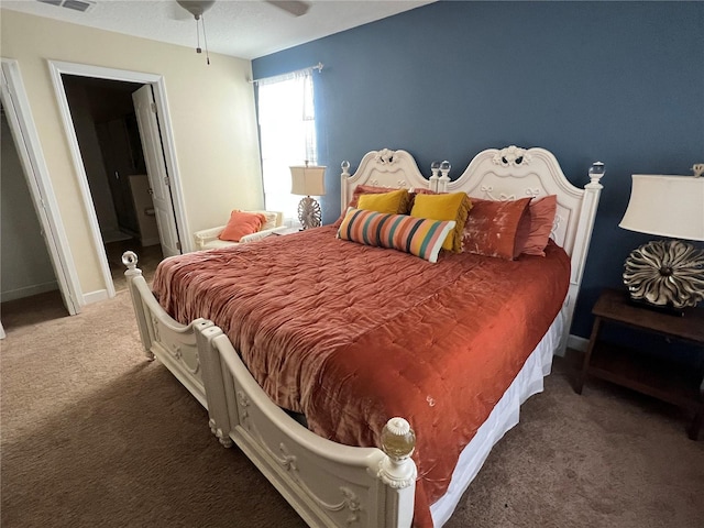 bedroom with connected bathroom, ceiling fan, and dark colored carpet