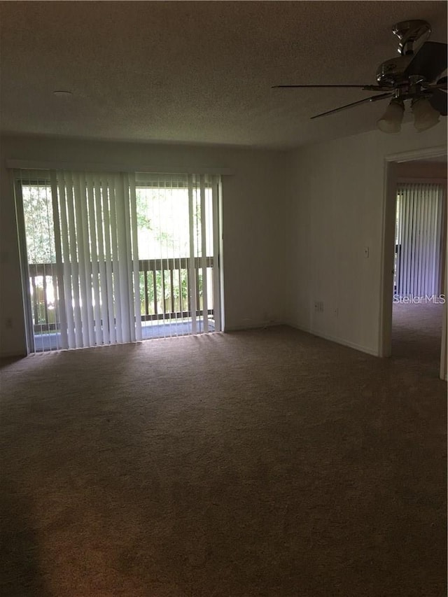 empty room with ceiling fan, carpet floors, and a textured ceiling