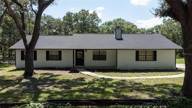 ranch-style house featuring a front lawn