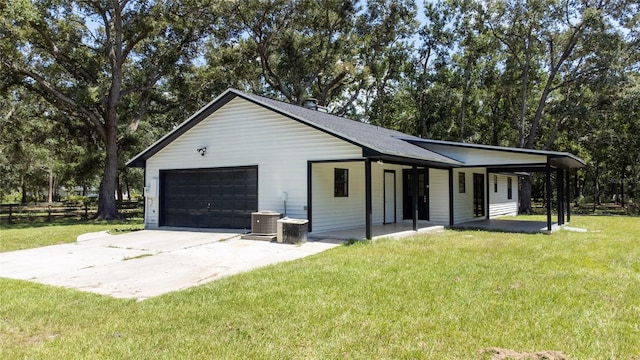 view of front facade with a front yard, covered porch, and a garage