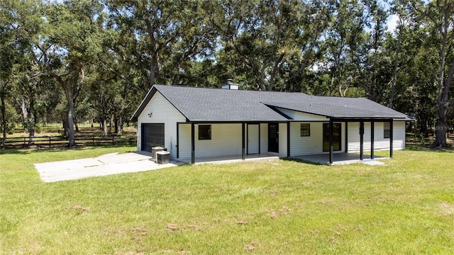 rear view of house with a yard and a patio area