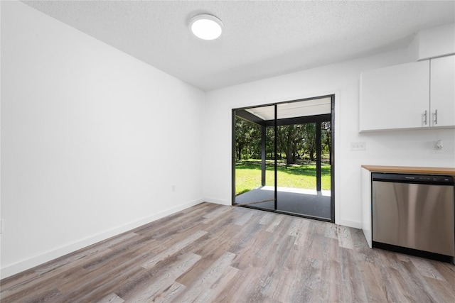 empty room featuring a textured ceiling and light wood-type flooring