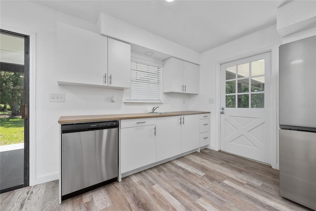 kitchen featuring white cabinets, light hardwood / wood-style flooring, sink, and stainless steel appliances