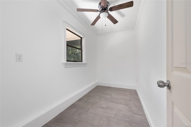 tiled empty room featuring crown molding and ceiling fan