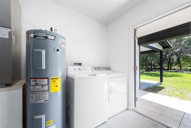 laundry room with washer hookup, water heater, and independent washer and dryer