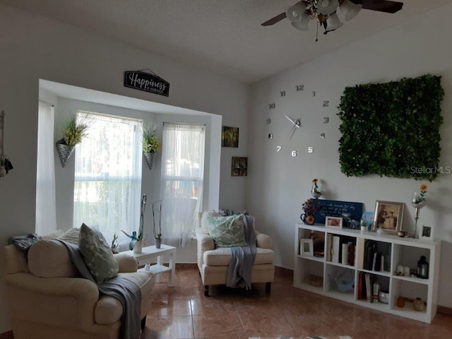 sitting room featuring tile patterned flooring, vaulted ceiling, and ceiling fan