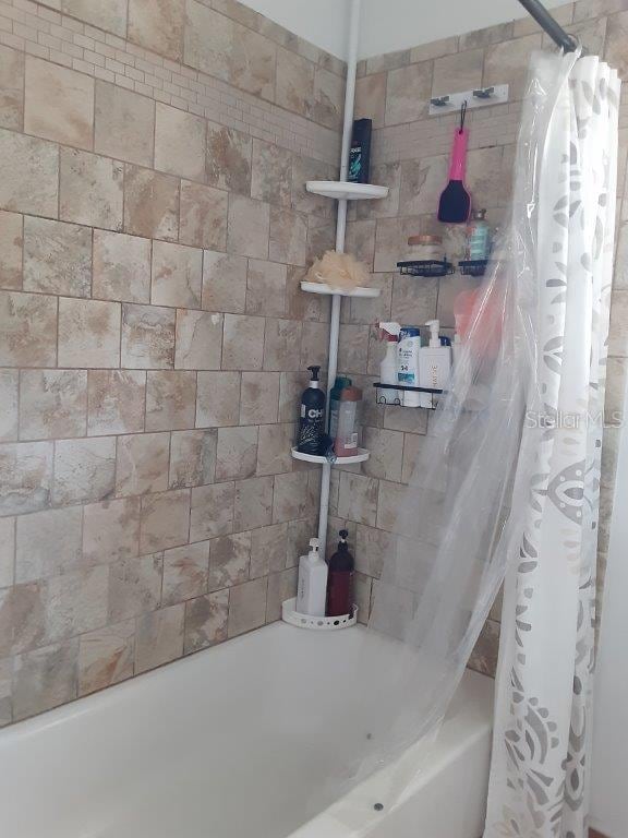 bathroom featuring shower / bath combination with curtain