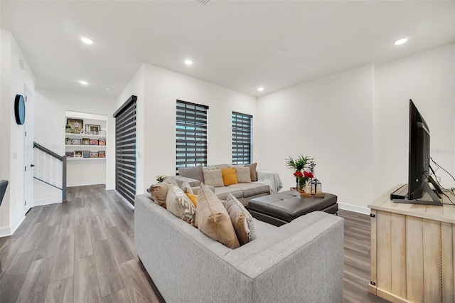 living room featuring hardwood / wood-style floors and built in features