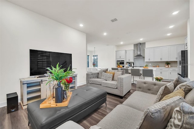 living room with dark hardwood / wood-style flooring and sink