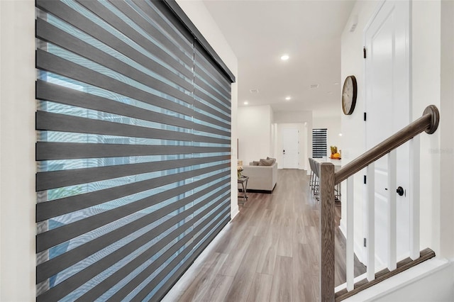 corridor with light hardwood / wood-style floors