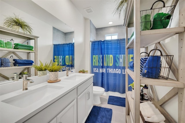 bathroom featuring toilet, vanity, a shower with curtain, and tile patterned flooring