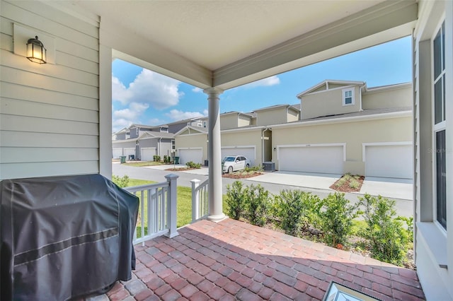 view of patio with a porch, grilling area, and a garage