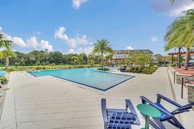 view of pool with a pergola and a patio area