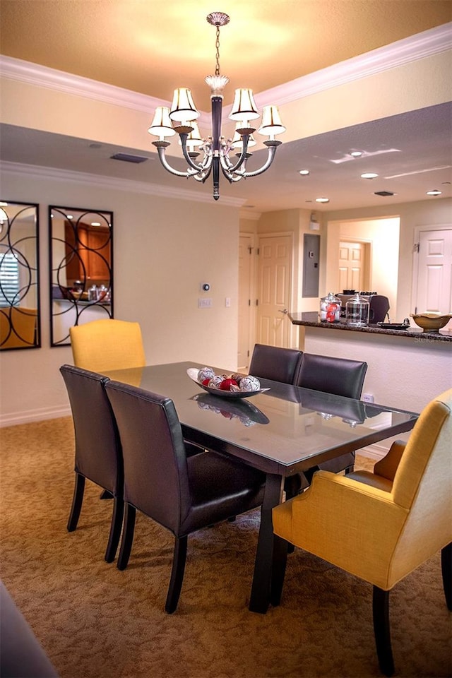 carpeted dining area featuring ornamental molding and a notable chandelier