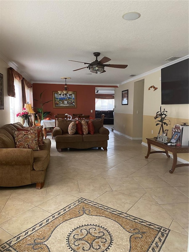 tiled living room featuring a textured ceiling, crown molding, ceiling fan, and a healthy amount of sunlight