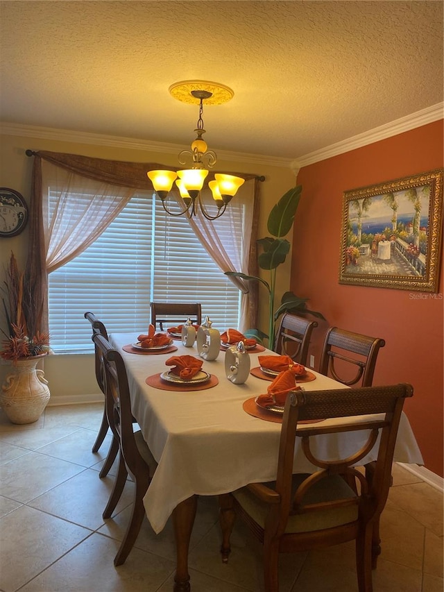 dining area featuring light tile floors, a chandelier, and ornamental molding