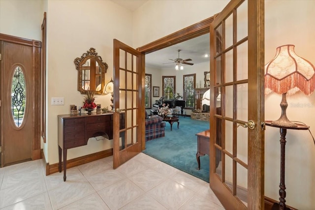 tiled entrance foyer with french doors and ceiling fan