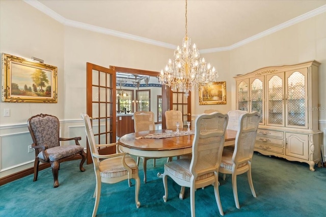 dining space with a chandelier, dark colored carpet, and crown molding