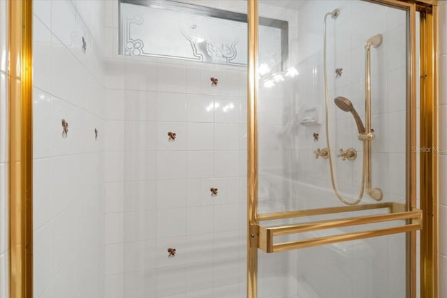 bathroom featuring a shower with door