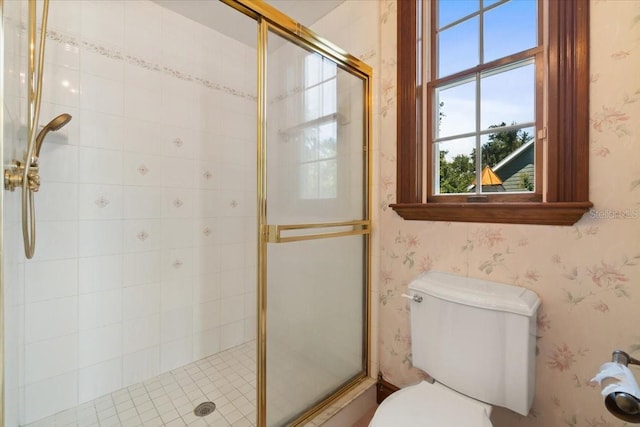 bathroom with toilet and a shower with shower door