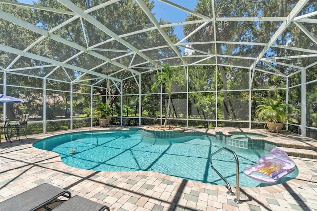 view of pool with an in ground hot tub, a lanai, and a patio