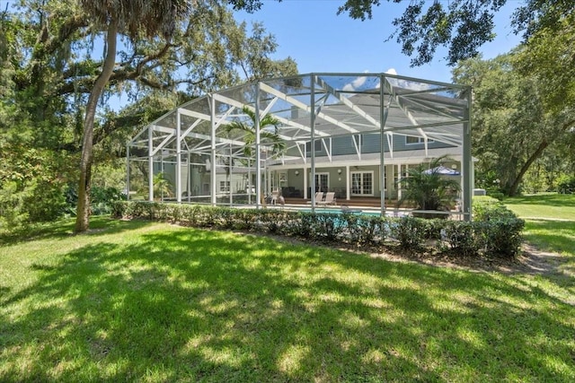 back of property with a patio area, a lanai, and a yard