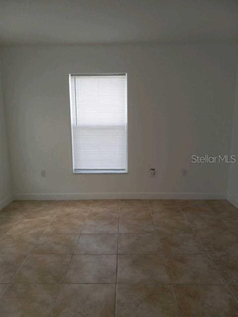 spare room featuring tile patterned flooring