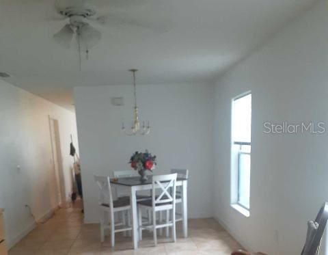 tiled dining space with ceiling fan