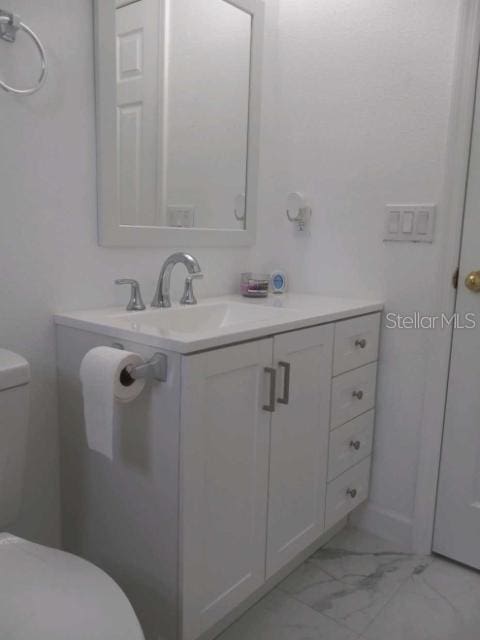 bathroom with vanity and toilet