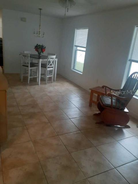 unfurnished dining area with light tile patterned flooring