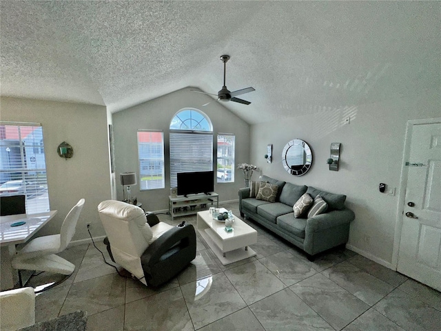 living room with lofted ceiling, light tile floors, ceiling fan, and a textured ceiling