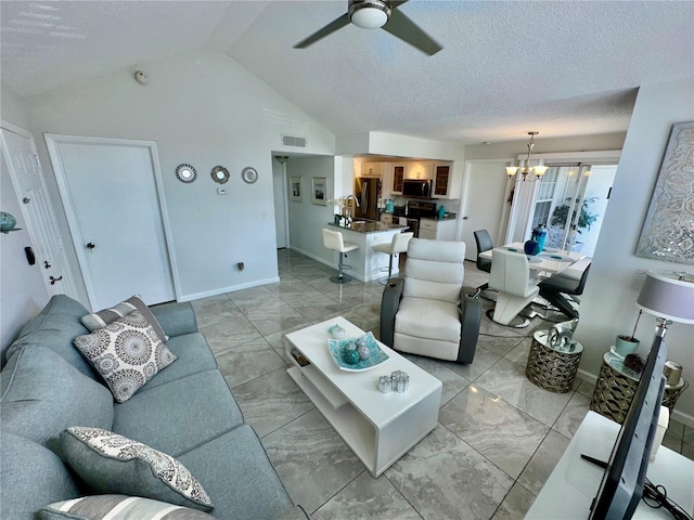 tiled living room featuring vaulted ceiling, sink, and ceiling fan with notable chandelier