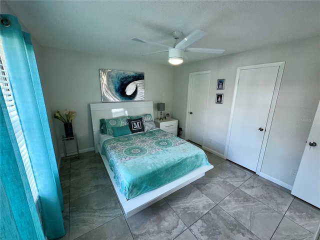 bedroom featuring tile floors and ceiling fan