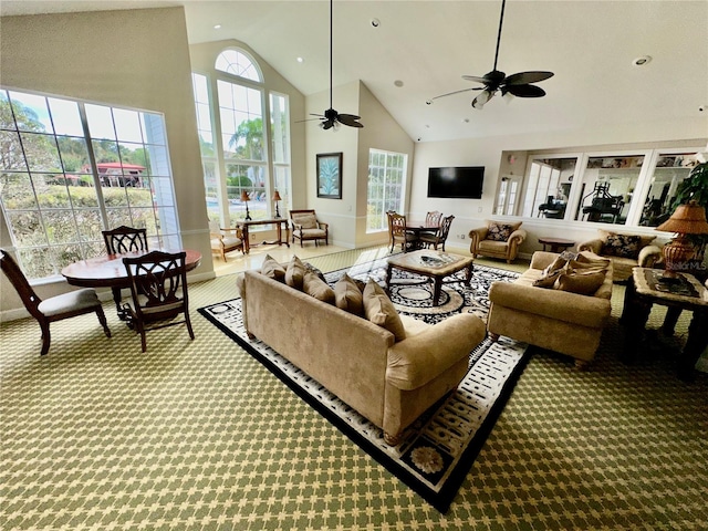 living room featuring light carpet, ceiling fan, and high vaulted ceiling