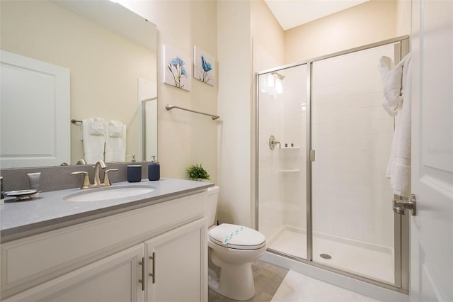 bathroom with an enclosed shower, oversized vanity, and toilet