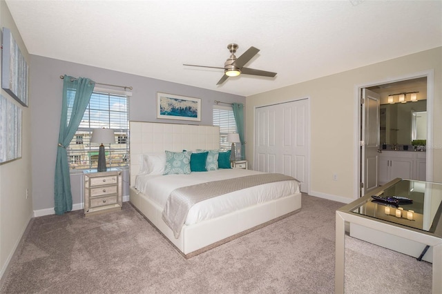 carpeted bedroom featuring ensuite bath, a closet, and ceiling fan